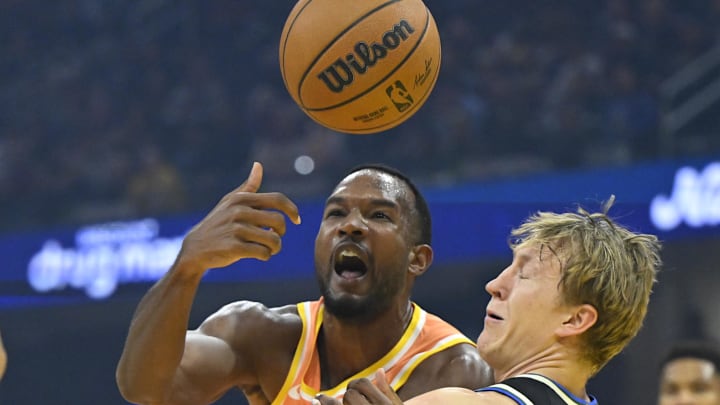 Nov 17, 2025; Cleveland, Ohio, USA; Cleveland Cavaliers center Evan Mobley (4) loses the ball beside Milwaukee Bucks guard AJ Green (20) in the first quarter at Rocket Arena. Mandatory Credit: David Richard-Imagn Images