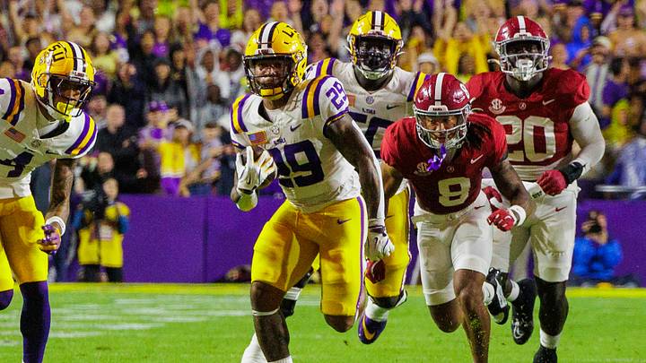LSU Tigers running back Caden Durham (29) breaks free in the open field against Alabama Crimson Tide defensive back DeVonta Smith (8) at Tiger Stadium. 