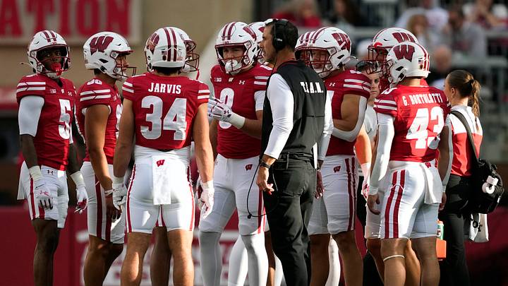 Sep 6, 2025; Madison, Wisconsin, USA;  Wisconsin Badgers head coach Luke Fickell talks with his team during a timeout against the Middle Tennessee Blue Raiders during the second half at Camp Randall Stadium. Mandatory Credit: Kayla Wolf-Imagn Images