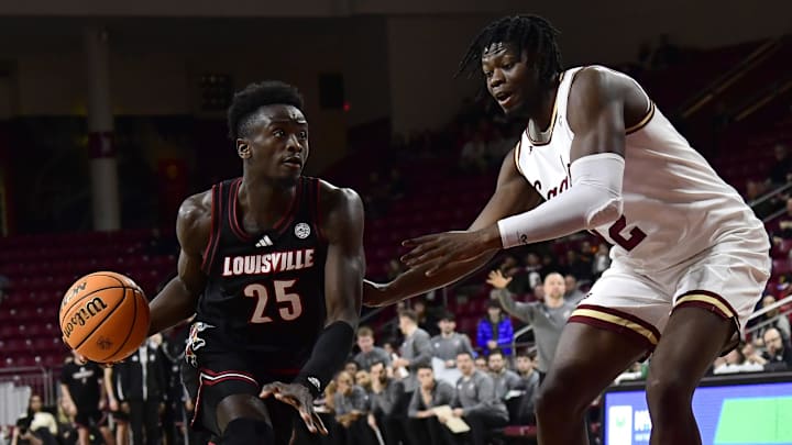 Feb 5, 2025; Chestnut Hill, Massachusetts, USA;  Louisville Cardinals forward Aboubacar Traore (25) controls the ball while Boston College Eagles forward Jayden Hastings (22) defends during the first half at Conte Forum. 