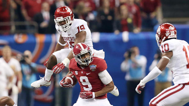 Alabama Crimson Tide wide receiver Amari Cooper runs from Oklahoma Sooners linebacker Eric Striker in the 2014 Sugar Bowl