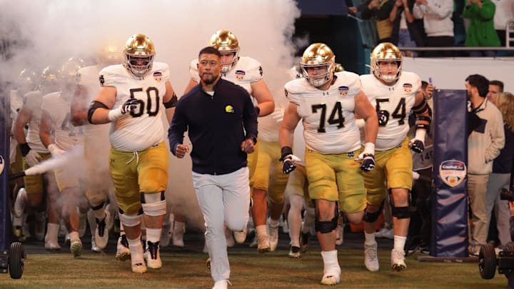 (EDITORS NOTE: caption correction) Jan 9, 2025; Miami, FL, USA; Notre Dame Fighting Irish head coach Marcus Freeman leads the team onto the field before the game against the Penn State Nittany Lions in the Orange Bowl at Hard Rock Stadium. (EDITORS NOTE: caption correction) Jan 9, 2025; Miami, FL, USA; Notre Dame Fighting Irish head coach Marcus Freeman leads the team onto the field before the game against the Penn State Nittany Lions in the Orange Bowl at Hard Rock Stadium.