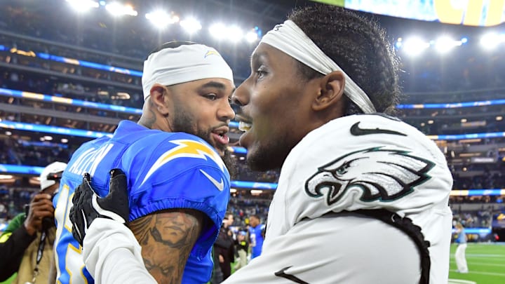 Dec 8, 2025; Inglewood, California, USA; Los Angeles Chargers wide receiver Keenan Allen (13) meets with Philadelphia Eagles cornerback Adoree' Jackson (8) after the game at SoFi Stadium. Mandatory Credit: Gary A. Vasquez-Imagn Images