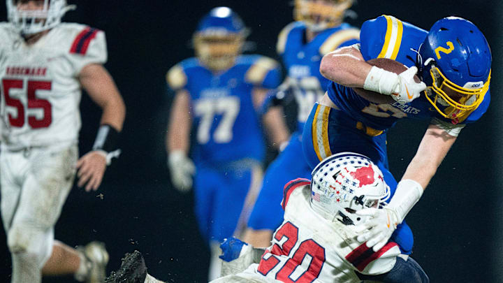 Tipton-Rosemark's Dominic Dotson (20) tries to bring down DCA's Carson Sneed (2) after a catch during their Division II-A playoff game at Donelson Christian Academy in Nashville, Tenn., Friday, Nov. 8, 2024.