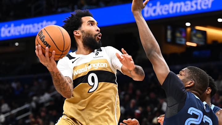 Dec 28, 2025; Washington, District of Columbia, USA; Washington Wizards forward Justin Champagnie (9) shoots over Memphis Grizzlies forward Cedric Coward (23) during the second half at Capital One Arena. Mandatory Credit: Brad Mills-Imagn Images