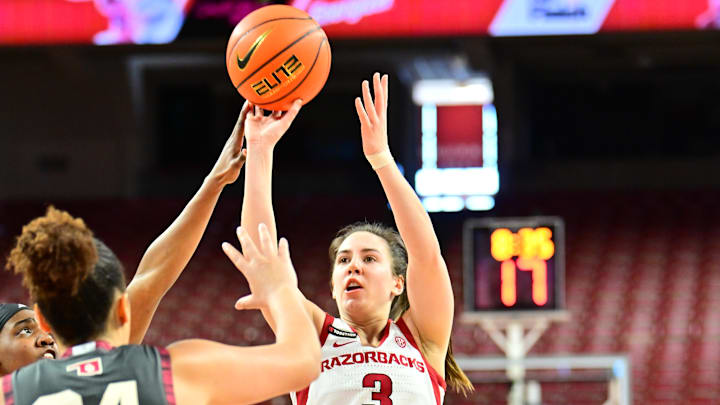 Guard Izzy Higginbottom shoots over an Oklahoma defender against the Sooners inside Bud Walton Arena on senior night. Oklahoma won 94-54.