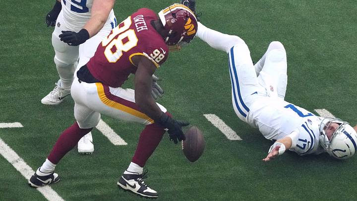 Oct 4, 2026; Tottenham, ENG;  Washington Commanders linebacker Odafe Oweh (98) sacks Indianapolis Colts quarterback Daniel Jones (17) during the first quarter at Tottenham Hotspur Stadium.  Mandatory Credit: Kirby Lee-Imagn Images
