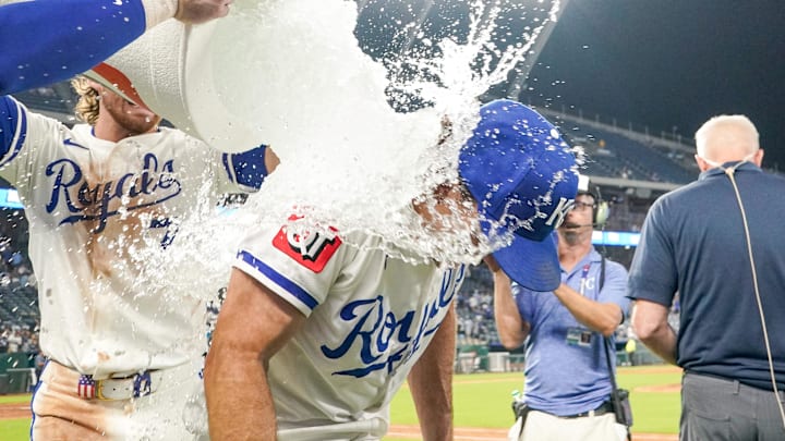 Kansas City Royals second baseman Adam Frazier (26) is doused by shortstop Bobby Witt Jr. (7) and right fielder designated hitter Carter Jensen (22) after the win over the Seattle Mariners at Kauffman Stadium.