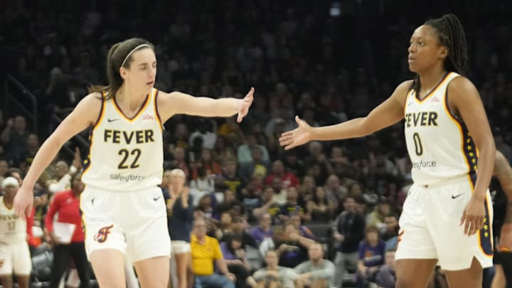 Jun 30, 2024; Phoenix, Ariz., U.S.; Indiana Fever guard Caitlin Clark (22) slaps hands with guard Kelsey Mitchell (0) during the third quarter against the Phoenix Mercury at Footprint Center. Mandatory Credit: Michael Chow-Arizona Republic
