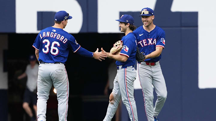 Texas Rangers' Wyatt Langford, Josh Smith, and Evan Carter celebrate.