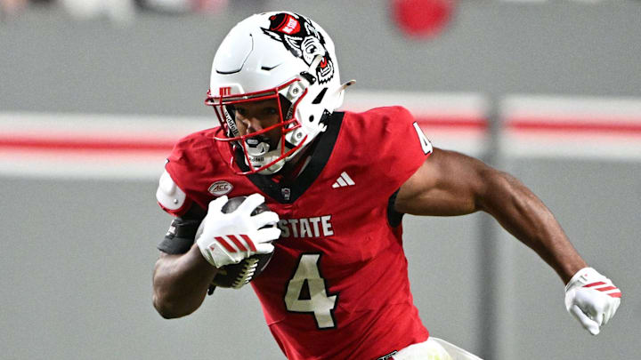 Nov 1, 2025; Raleigh, North Carolina, USA; North Carolina State Wolfpack running back Jayden Scott (4) runs the ball around Georgia Tech Yellow Jackets linebacker E.J. Lightsey (2) during the first quarter at Carter-Finley Stadium. Mandatory Credit: Zachary Taft-Imagn Images Nov 1, 2025; Raleigh, North Carolina, USA; North Carolina State Wolfpack running back Jayden Scott (4) runs the ball around Georgia Tech Yellow Jackets linebacker E.J. Lightsey (2) during the first quarter at Carter-Finley Stadium. Mandatory Credit: Zachary Taft-Imagn Images