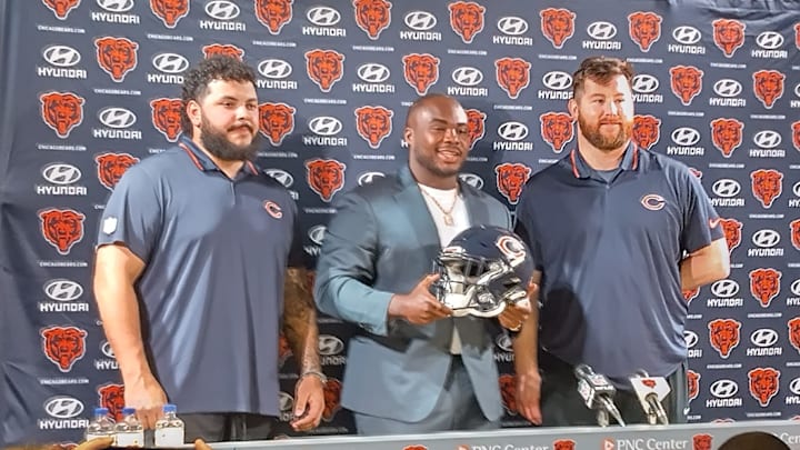 Jonah Jackson, Grady Jarrett and Joe Thuney pose with their new helmet after signing with the Bears this week.