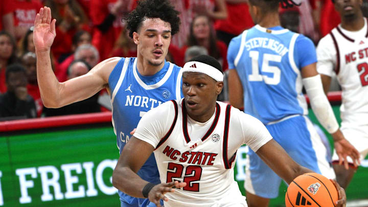 Feb 17, 2026; Raleigh, North Carolina, USA; NC State Wolfpack forward Ven-Allen Lubin (22) drives the ball to the basket against North Carolina Tar Heels forward Zayden High (1) during the first half at Lenovo Center. Mandatory Credit: Zachary Taft-Imagn Images