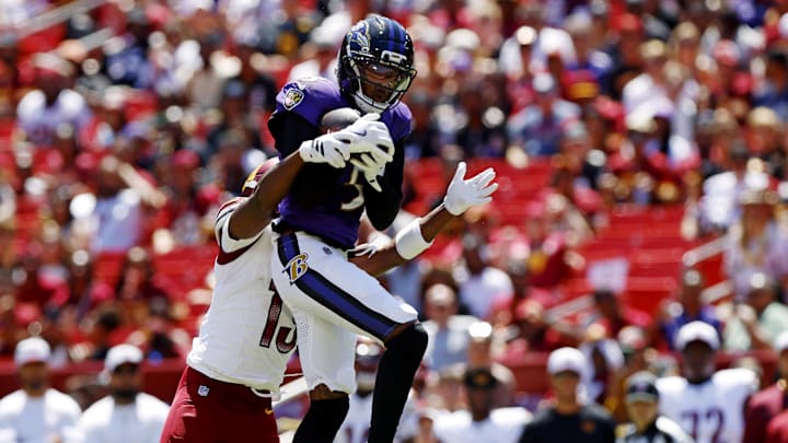 Baltimore Ravens cornerback Jalyn Armour-Davis intercepts a pass intended for Washington Commanders wide receiver K.J. Osborn