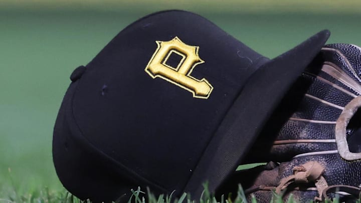 Sep 16, 2025; Pittsburgh, Pennsylvania, USA; A hat and glove belonging to Pittsburgh Pirates third baseman Jared Triolo (not pictured) on the field against the Chicago Cubs during the sixth inning at PNC Park. Mandatory Credit: Charles LeClaire-Imagn Images Sep 16, 2025; Pittsburgh, Pennsylvania, USA; A hat and glove belonging to Pittsburgh Pirates third baseman Jared Triolo (not pictured) on the field against the Chicago Cubs during the sixth inning at PNC Park. Mandatory Credit: Charles LeClaire-Imagn Images