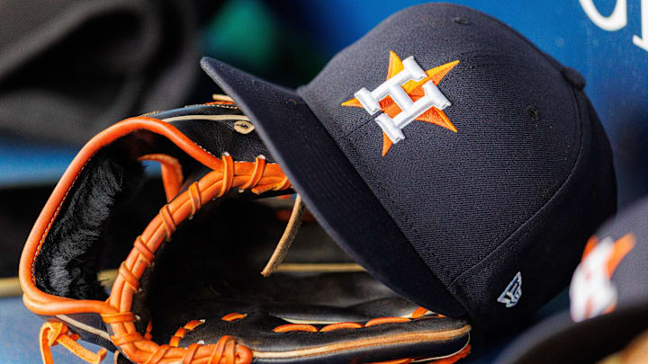 Apr 27, 2025; Kansas City, Missouri, USA; Houston Astros hat and glove in the dugout during the second inning against the Kansas City Royals at Kauffman Stadium. 