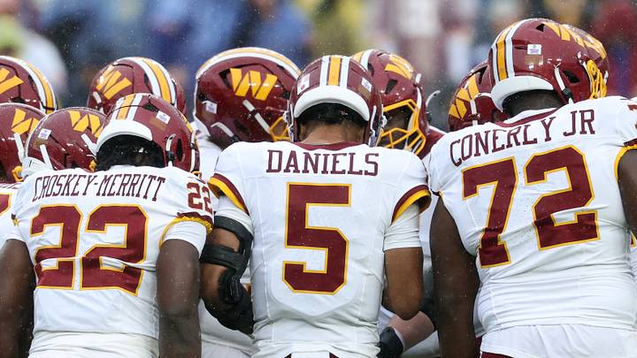 Oct 11, 2026; Landover, Maryland, USA; Washington Commanders quarterback Jayden Daniels (5) stands in the huddle with his team against the New York Giants at Northwest Stadium. Mandatory Credit: Geoff Burke-Imagn Images Oct 11, 2026; Landover, Maryland, USA; Washington Commanders quarterback Jayden Daniels (5) stands in the huddle with his team against the New York Giants at Northwest Stadium. Mandatory Credit: Geoff Burke-Imagn Images