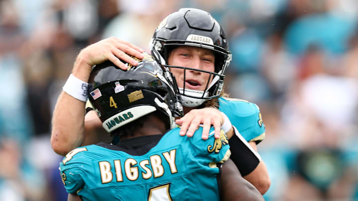 Oct 6, 2024; Jacksonville, Florida, USA; Jacksonville Jaguars running back Tank Bigsby (4) celebrates with quarterback Trevor Lawrence (16) after scoring a touchdown against the Indianapolis Colts in the fourth quarter at EverBank Stadium. Mandatory Credit: Nathan Ray Seebeck-Imagn Images