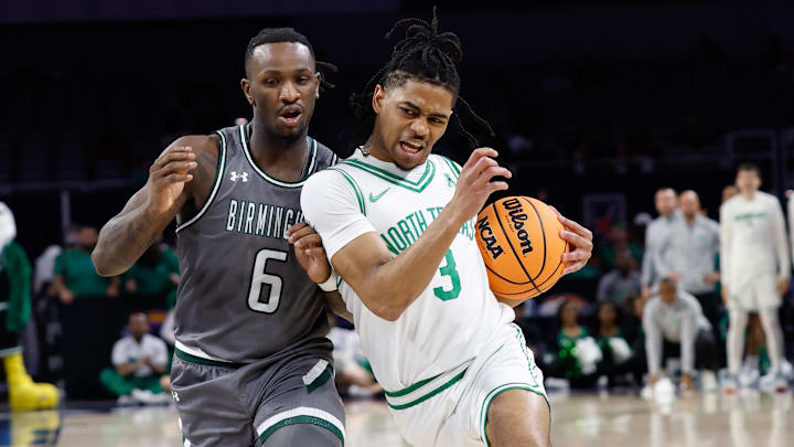 Mar 15, 2025; Fort Worth, TX, USA;  North Texas Mean Green guard Jasper Floyd (3) drives to the basket as UAB Blazers guard Tony Toney (6) defends during the first half at Dickies Arena. 