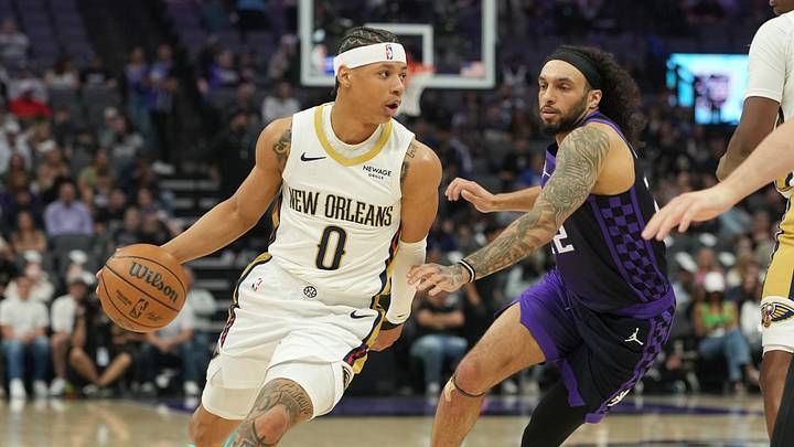 Apr 3, 2026; Sacramento, California, USA; New Orleans Pelicans guard Jeremiah Fears (0) dribbles against Sacramento Kings guard Devin Carter (center right) during the second quarter at Golden 1 Center. Mandatory Credit: Darren Yamashita-Imagn Images