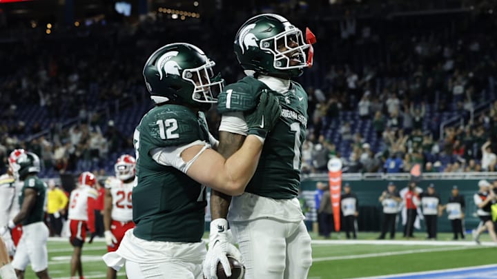 Michigan State Spartans wide receiver Omari Kelly (1) celebrates a touchdown with tight end Jack Velling (12) during a game against the Maryland Terrapins at Ford Field on Saturday, Nov. 29, 2025.