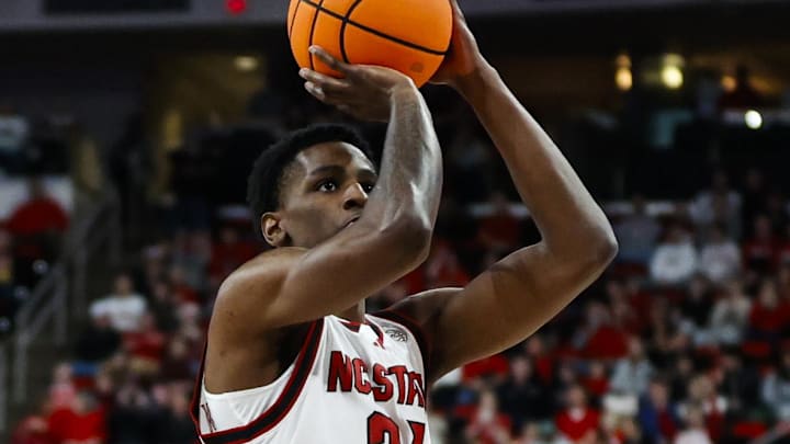 Dec 6, 2025; Raleigh, North Carolina, USA; NC State Wolfpack guard Terrance Arceneaux (21) shoots a free throw during the first half of the game against UNC Asheville Bulldogs at Lenovo Center. Mandatory Credit: Jaylynn Nash-Imagn Images