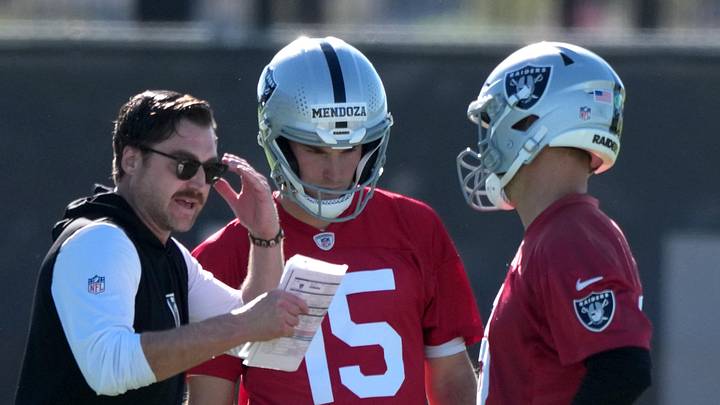 Las Vegas Raiders offensive coordinator Andrew Janocko (left) talks with quarterbacks Fernando Mendoza (15) and Kirk Cousins (8) during minicamp.