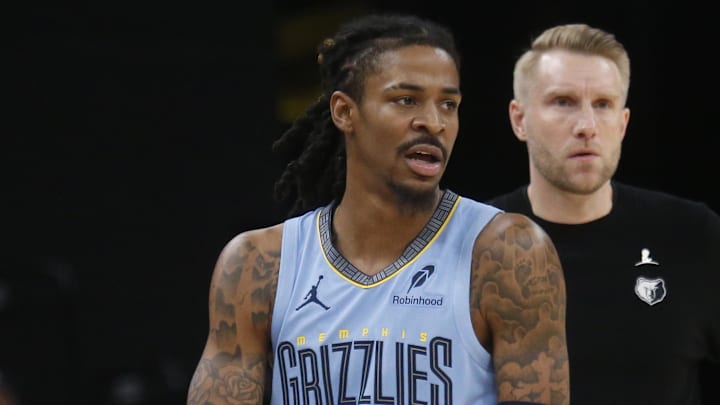 Jan 21, 2026; Memphis, Tennessee, USA; Memphis Grizzlies guard Ja Morant (12) and head coach Tuomas Iisalo looks on during the third quarter against the Atlanta Hawks at FedExForum.