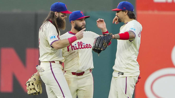 Sep 14, 2024; Philadelphia, Pennsylvania, USA; Philadelphia Phillies left fielder Brandon Marsh (16) and center fielder Cal Stevenson (47) and right fielder Nick Castellanos (8) celebrate after defeating the New York Mets at Citizens Bank Park