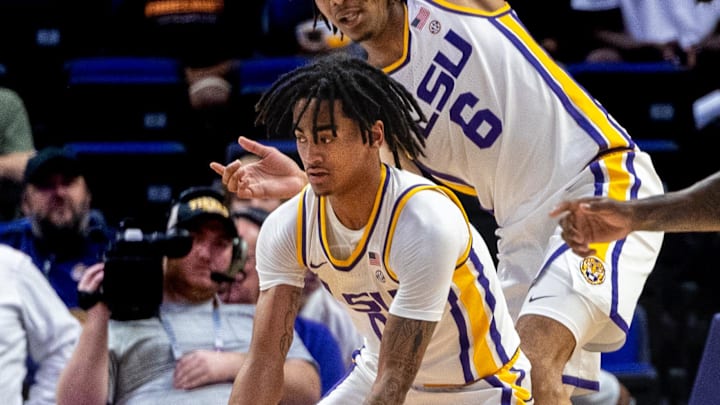 Nov 19, 2024; Baton Rouge, Louisiana, USA;  LSU Tigers guard Vyctorius Miller (0) grabs a rebound against Charleston Southern Buccaneers forward Lase Olalere (34) during the first half at Pete Maravich Assembly Center. Mandatory Credit: Stephen Lew-Imagn Images