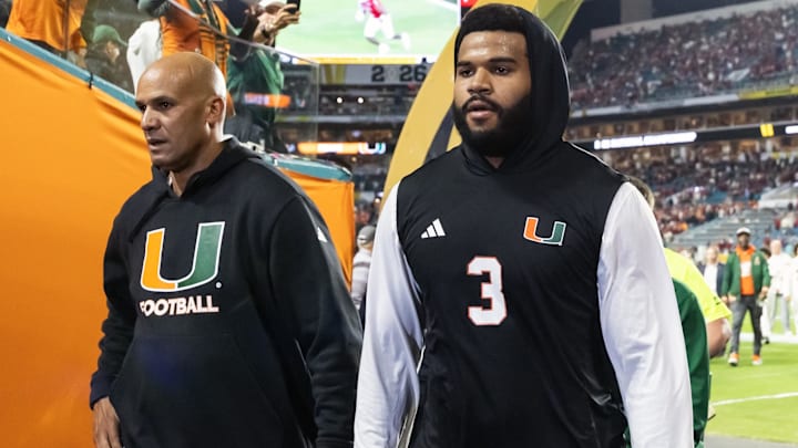 Jan 19, 2026; Miami Gardens, FL, USA; Miami Hurricanes defensive lineman Akheem Mesidor (3) with coach Jason Taylor against the Indiana Hoosiers during the College Football Playoff National Championship game at Hard Rock Stadium. Mandatory Credit: Mark J. Rebilas-Imagn Images