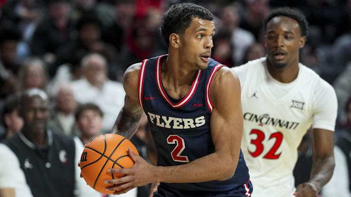 Nov 11, 2025; Cincinnati, Ohio, USA; Dayton Flyers guard De'Shayne Montgomery (2) steals the ball away from Cincinnati Bearcats forward Jalen Celestine (32) in the second half at Fifth Third Arena. Mandatory Credit: Aaron Doster-Imagn Images