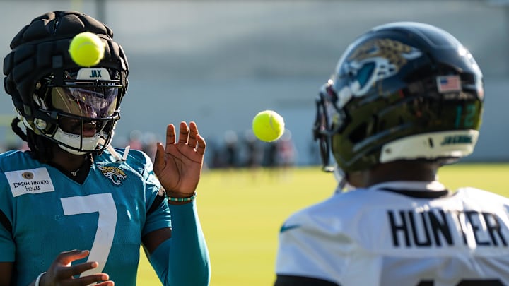 Jacksonville Jaguars wide receiver Brian Thomas Jr. (7) and Jacksonville Jaguars wide receiver Travis Hunter (12) use tennis balls in a drill during an NFL training camp fourth session at the Miller Electric Center, Sunday, July 27, 2025, in Jacksonville, Fla. [Doug Engle/Florida Times-Union]