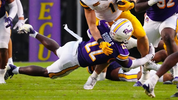 Sep 14, 2024; Greenville, North Carolina, USA;  Appalachian State Mountaineers running back Anderson Castle (1) is stopped on his run by East Carolina Pirates defensive back Ja'Marley Riddle (22) during the second half at Dowdy-Ficklen Stadium. Mandatory Credit: James Guillory-Imagn Images