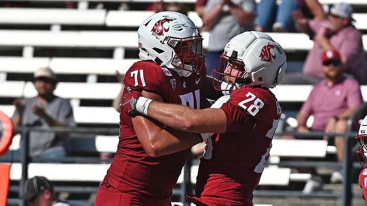 Washington State Cougars tight end Jack Pedersen (28) and offensive lineman Ashton Tripp (71) celebrate a touchdown against the Duquesne Dukes during the second half at Gesa Field at Martin Stadium. Washington State Cougars tight end Jack Pedersen (28) and offensive lineman Ashton Tripp (71) celebrate a touchdown against the Duquesne Dukes during the second half at Gesa Field at Martin Stadium.