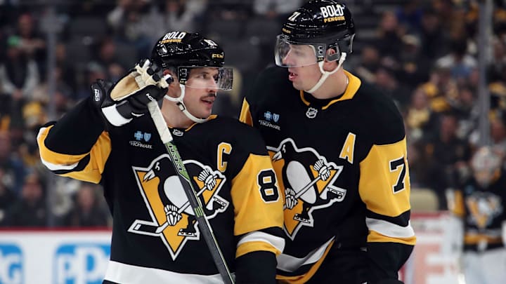 Nov 27, 2024; Pittsburgh, Pennsylvania, USA;  Pittsburgh Penguins center Sidney Crosby (87) and center Evgeni Malkin (71) talk before a face-off against the Vancouver Canucks during the third period at PPG Paints Arena. Mandatory Credit: Charles LeClaire-Imagn Images