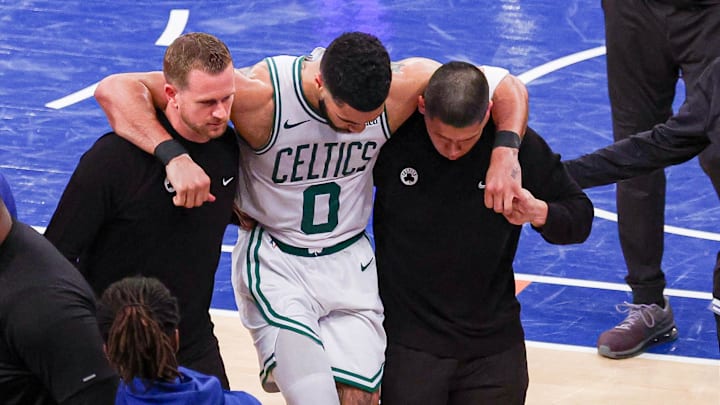 Jayson Tatum (center) injured his right lower leg and the Celtics odds to win the title dropped as a result. 