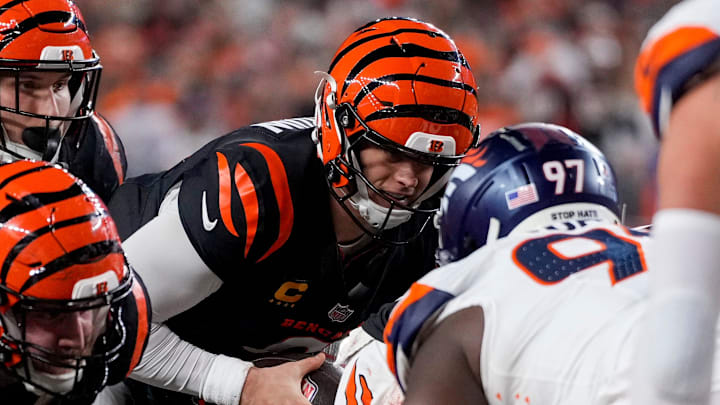 Cincinnati Bengals quarterback Joe Burrow (9) scores a touchdown on a QB sneak up the middle in the fourth quarter of the NFL Week 17 game between the Cincinnati Bengals and the Denver Broncos at Paycor Stadium in downtown Cincinnati on Saturday, Dec. 28, 2024. The Bengals took a 30-24 win in overtime to remain in the post season chase.