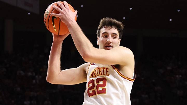 Feb 14, 2026; Ames, Iowa, USA; Iowa State Cyclones forward Milan Momcilovic (22) grabs a rebound against the Kansas Jayhawks during the second half at James H. Hilton Coliseum.