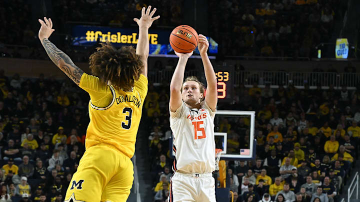 Mar 2, 2025; Ann Arbor, Michigan, USA; Illinois Fighting Illini forward Jake Davis (15) shoots a three point shot over Michigan Wolverines guard Tre Donaldson (3) in the second half at Crisler Center. Mandatory Credit: Lon Horwedel-Imagn Images