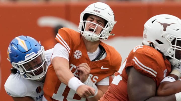 Sep 6, 2025; Austin, Texas, USA; Texas Longhorns quarterback Arch Manning (16) reacts after getting hit by San Jose State Spartans linebacker Taniela Latu (4) during the second half at Darrell K Royal-Texas Memorial Stadium.