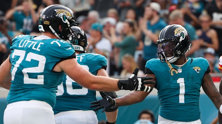 Aug 10, 2024; Jacksonville, Florida, USA; Jacksonville Jaguars running back Travis Etienne Jr. (1) celebrates with offensive tackle Walker Little (72) after scoring a touchdown against the Kansas City Chiefs in the first quarter during preseason at EverBank Stadium. Mandatory Credit: Nathan Ray Seebeck-Imagn Images