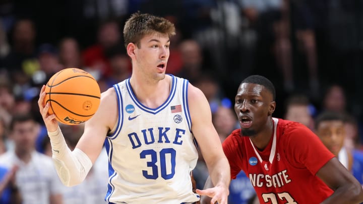 Mar 31, 2024; Dallas, TX, USA; Duke Blue Devils center Kyle Filipowski (30) controls the ball against North Carolina State Wolfpack forward Mohamed Diarra (23) in the second half in the finals of the South Regional of the 2024 NCAA Tournament at American Airline Center. Mandatory Credit: Kevin Jairaj-USA TODAY Sports