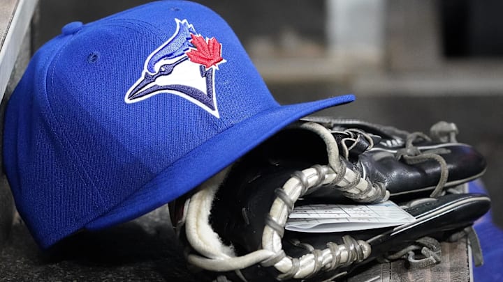 Apr 16, 2025; Toronto, Ontario, CAN; A Toronto Blue Jays hat and glove in the dugout during a game against the Atlanta Braves at Rogers Centre. Apr 16, 2025; Toronto, Ontario, CAN; A Toronto Blue Jays hat and glove in the dugout during a game against the Atlanta Braves at Rogers Centre.