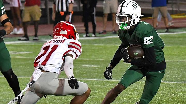 Mason's senior receiver Chris Hubbard (82) looks to take a pass reception for a Comets' first down in last season's Princeton vs. Mason football game Sept. 26, 2025, at Mason High School. Mason's senior receiver Chris Hubbard (82) looks to take a pass reception for a Comets' first down in last season's Princeton vs. Mason football game Sept. 26, 2025, at Mason High School.
