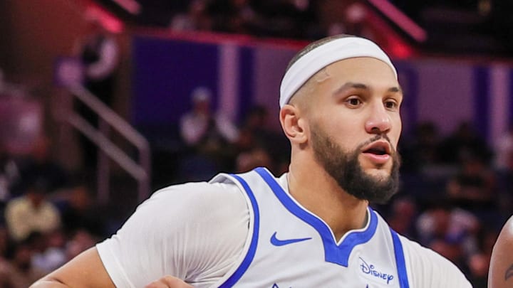 Brooklyn Nets center Nic Claxton drives against Orlando Magic guard Jalen Suggs.