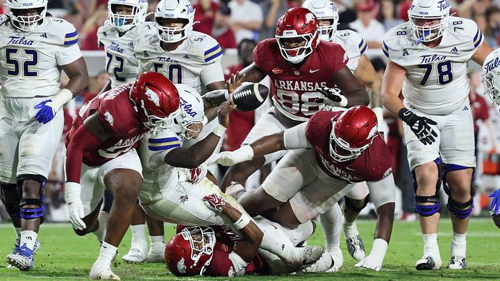 Tulsa Golden Hurricanes quarterback Dexter Williams II (5) fumbles the ball during the fourth quarter against the Arkansas Razorbacks at Razorback Stadium. 