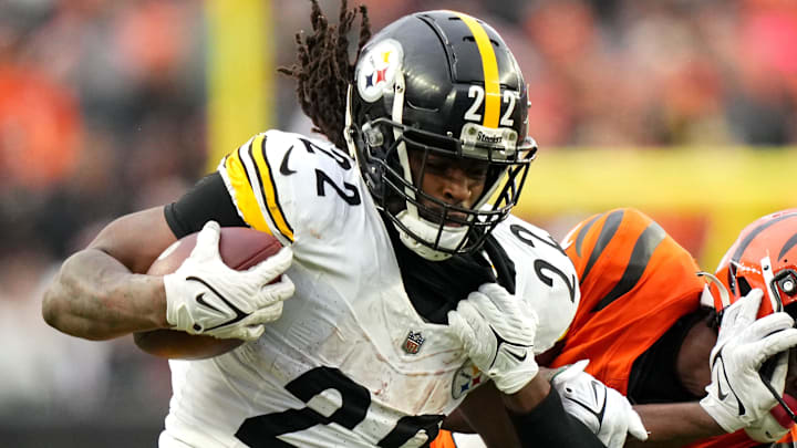 Pittsburgh Steelers running back Najee Harris (22) stiff arms Cincinnati Bengals cornerback Chidobe Awuzie (22) on a carry in the fourth quarter of a Week 12 NFL football game on Sunday, Nov. 26, 2023, at Paycor Stadium.