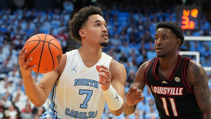 Feb 23, 2026; Chapel Hill, North Carolina, USA; North Carolina Tar Heels guard Seth Trimble (7) dribbles as Louisville Cardinals guard Kobe Rodgers (11) defends in the second half at Dean E. Smith Center. Mandatory Credit: Bob Donnan-Imagn Images