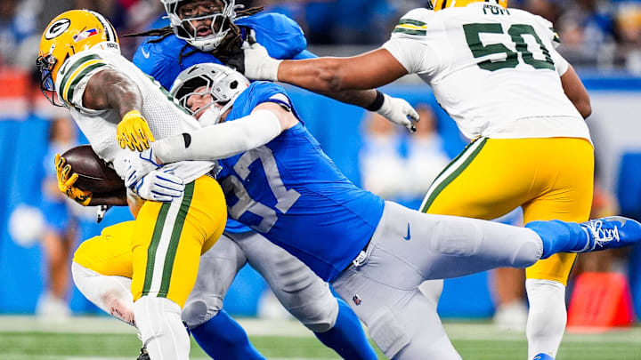 Detroit Lions defensive end Aidan Hutchinson (97) tackles Green Bay Packers running back Josh Jacobs (8)